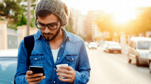 man on cell phone looking at social media